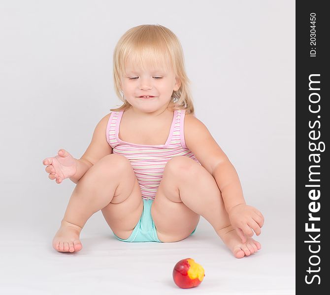 Adorable Girl Eat Red Fresh Peach Sitting On White