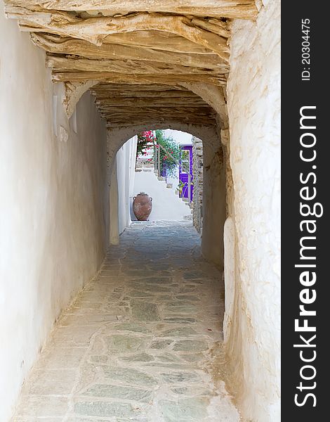 A tunnel-like alley, passing under a house, in the old section of Chora town, Folegandros island. A tunnel-like alley, passing under a house, in the old section of Chora town, Folegandros island