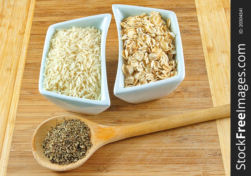 Rice, oats and herbs on the wooden board. Rice, oats and herbs on the wooden board