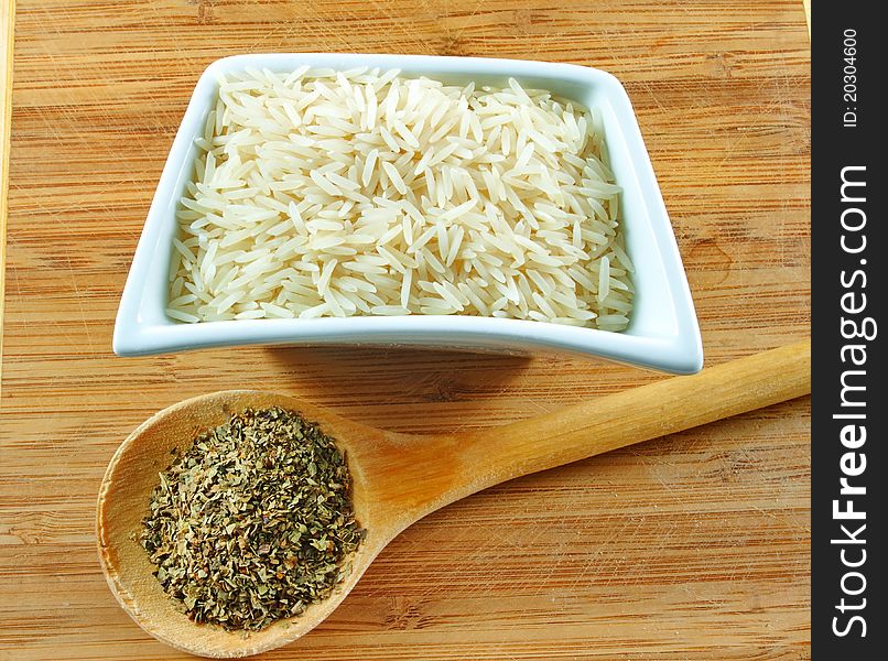 Rice and herbs on the wooden board