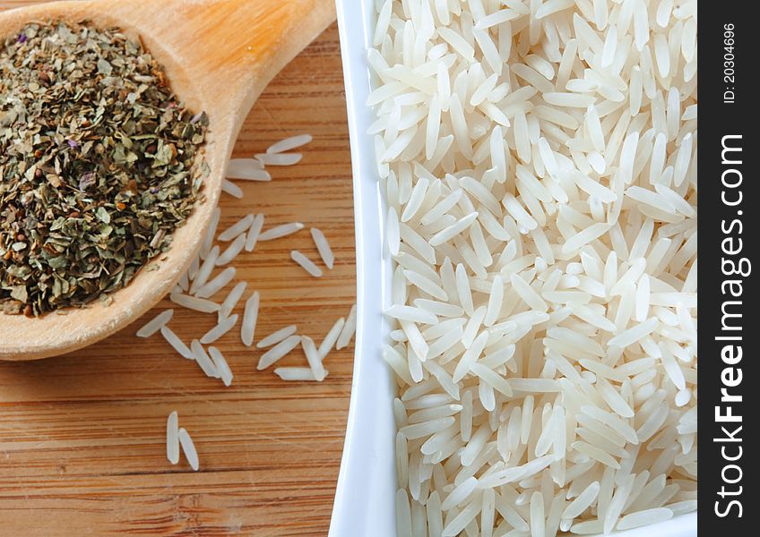 Rice and herbs on the wooden board