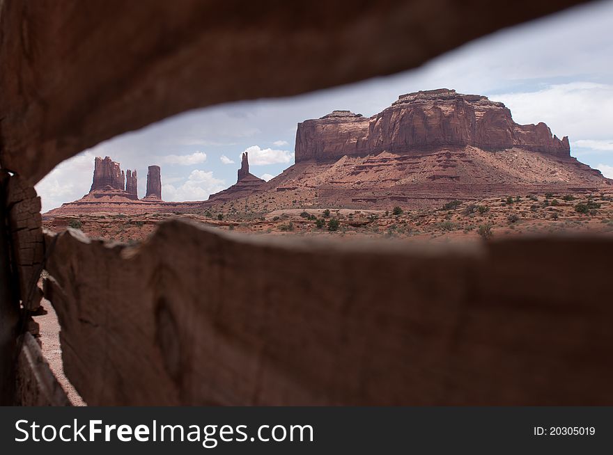 Monument Valley is viewed through an abandoned barn on route along Hwy 163 south from Utah into Arizona. Monument Valley is viewed through an abandoned barn on route along Hwy 163 south from Utah into Arizona