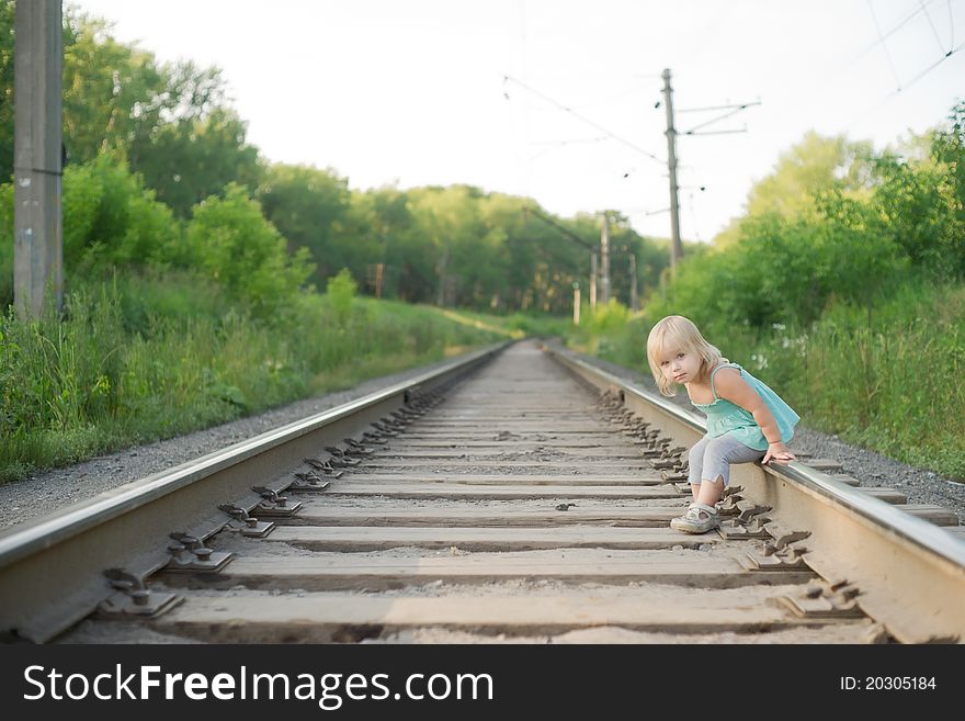 Adorable toddler girl sit on rail wait for train. Adorable toddler girl sit on rail wait for train