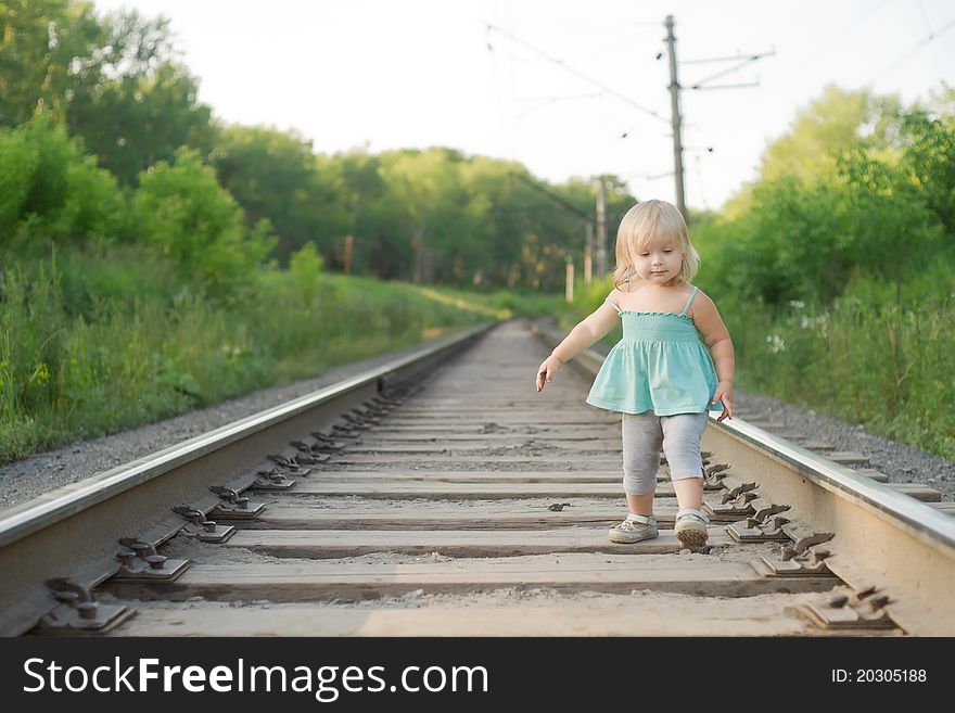 Adorable toddler girl walk along rails. Adorable toddler girl walk along rails