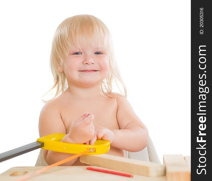 Adorable toddler girl work with wood and saw in workshop room. Adorable toddler girl work with wood and saw in workshop room