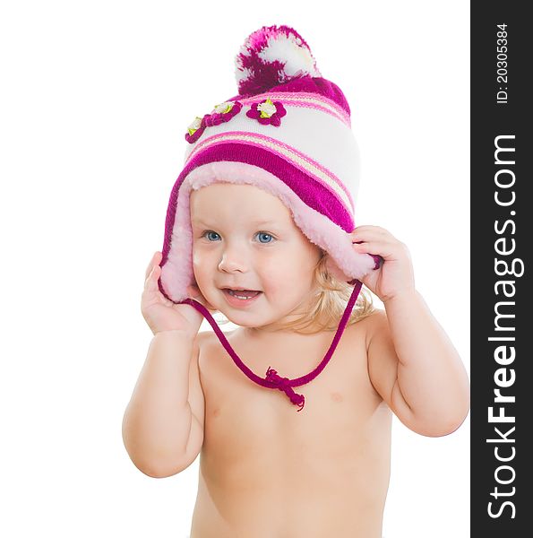 Adorable toddler girl putting on beautiful winter hat on head. Adorable toddler girl putting on beautiful winter hat on head