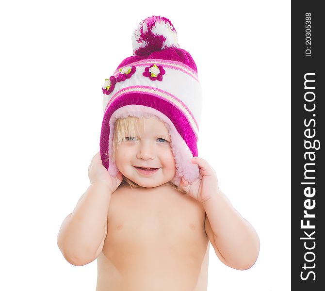 Adorable girl putting on winter hat on head