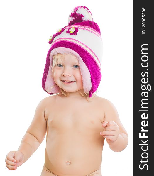 Adorable girl putting on winter hat on head