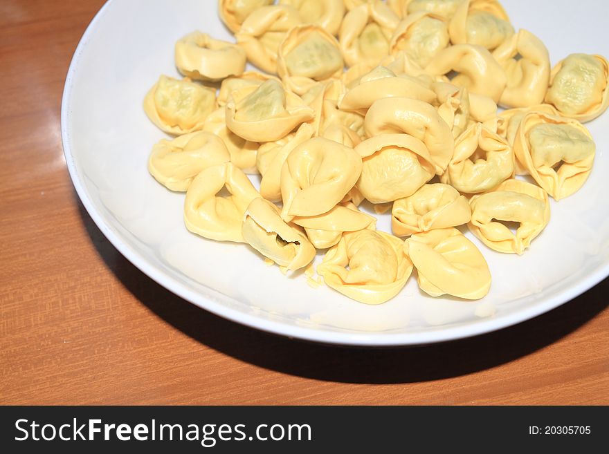 Tortellini with meat in a white dish