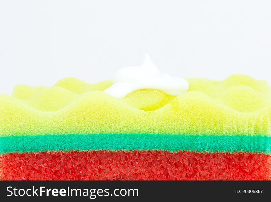 Beautiful tricolor sponge to wash the body on a white background. Beautiful tricolor sponge to wash the body on a white background