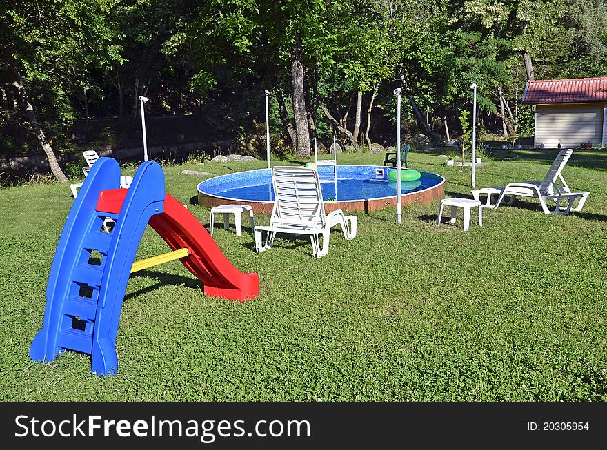 Children playing place with swimming pool near the forest. Children playing place with swimming pool near the forest