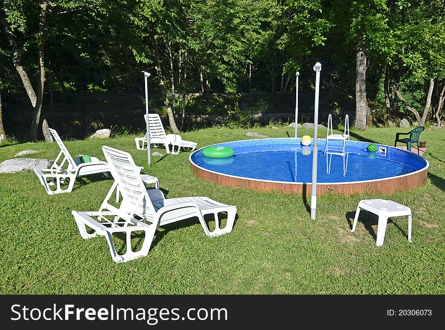 Children playing place with swimming pool near the forest. Children playing place with swimming pool near the forest