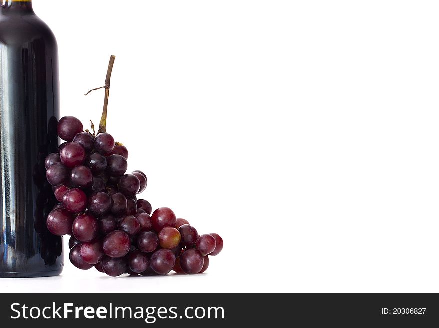 Bottle of wine with grapes isolated on white background
