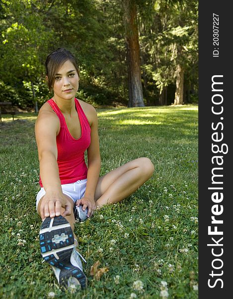 Young woman runner working out in a park