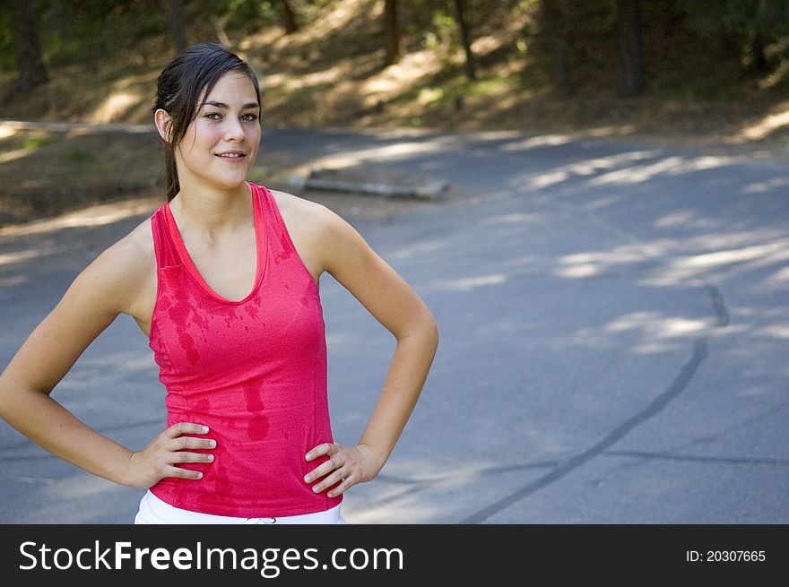 Young woman runner working out in a park