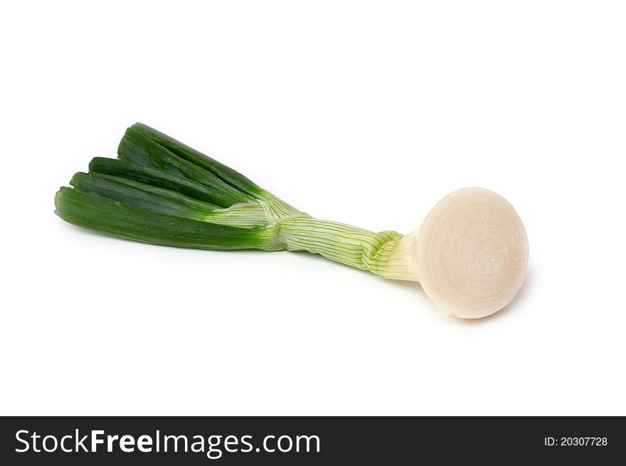 Fresh cut onion with green leaves on a white background