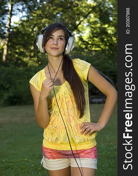 Young woman listening to music outdoors. Young woman listening to music outdoors