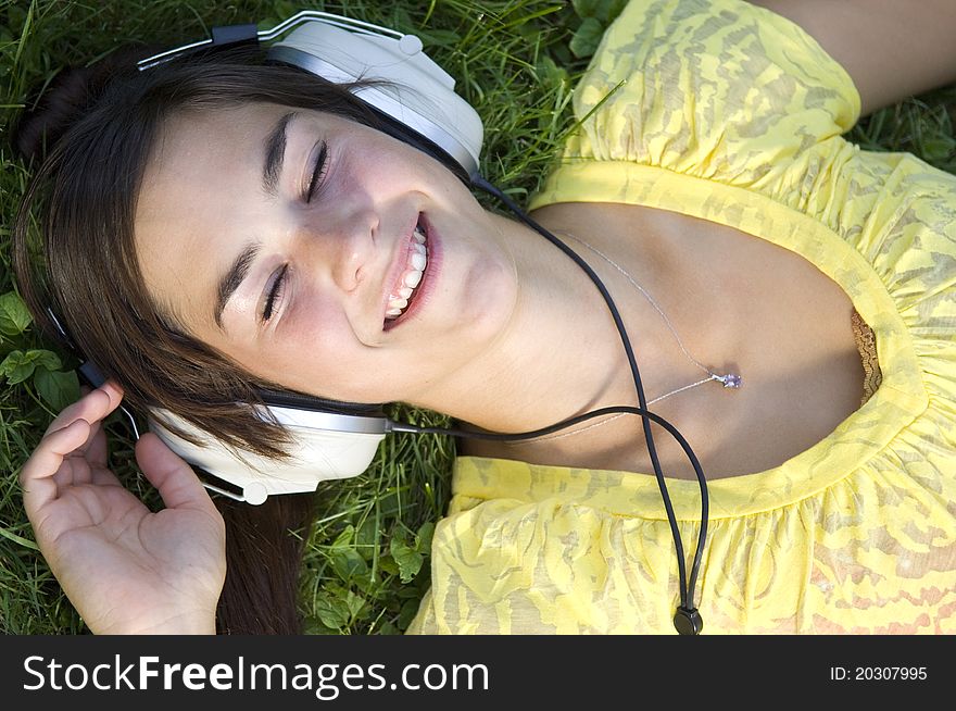 Young woman listening to music outdoors. Young woman listening to music outdoors