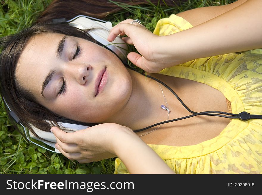 Young woman listening to music outdoors. Young woman listening to music outdoors