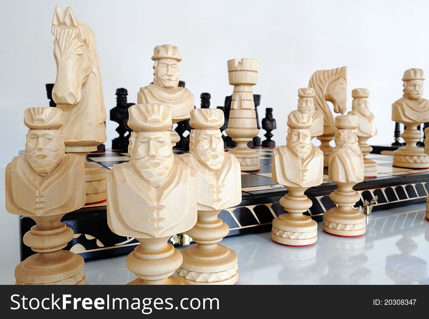 Chess pieces on wood board, black and white