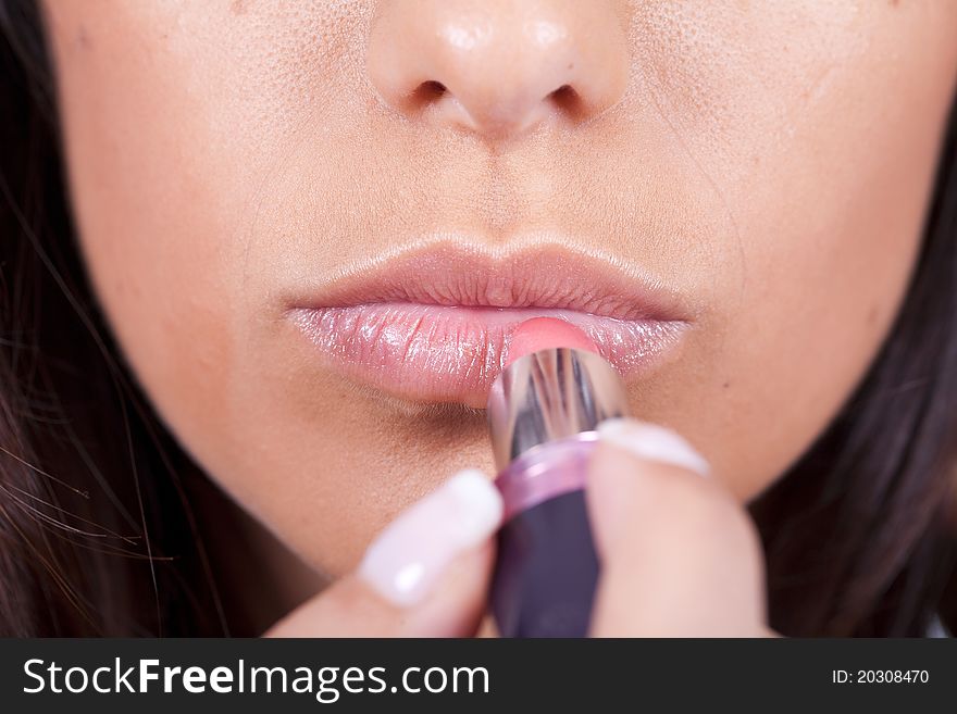 Beauty woman applying lipstick on lips