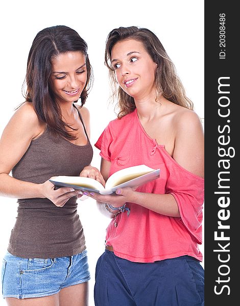 Two young and beautiful girls reading a book. Two young and beautiful girls reading a book