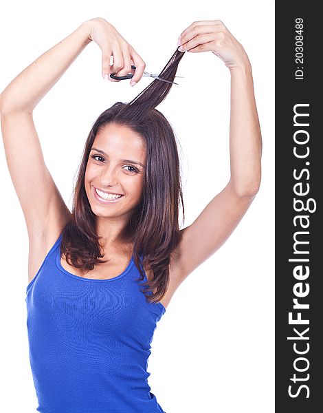 Beautiful woman cutting her hair tips with scissors