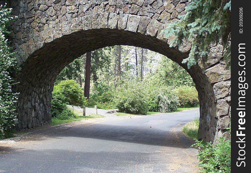 A road going through a stone tunnel.