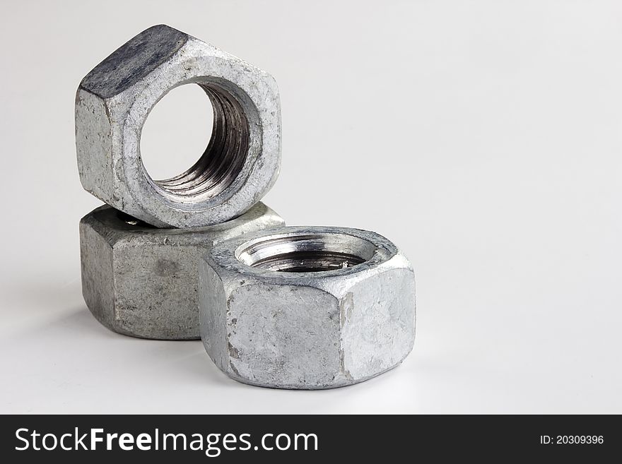 Silver metallic nuts isolated on a white background. Add your text to the background. Silver metallic nuts isolated on a white background. Add your text to the background.