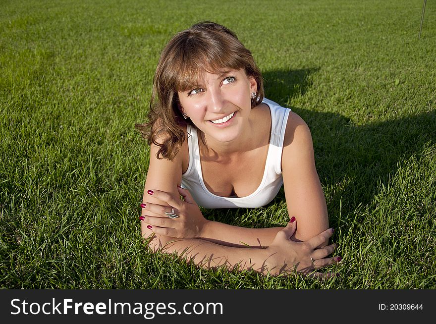 Beautiful Young Woman Smiling On Grass Field