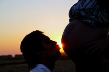 The Guy Kisses A Stomach Of The Pregnant Stock Image
