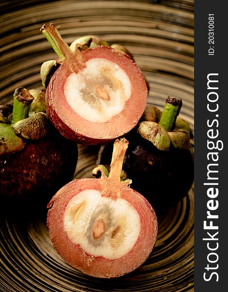 Mangosteens in a wooden bowl