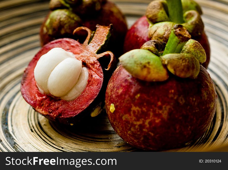 Mangosteens in a wooden bowl