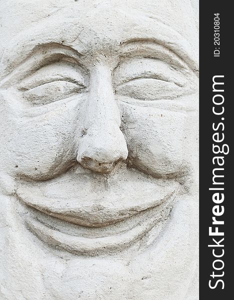 Cement sculpture of smiling face. Cement sculpture of smiling face
