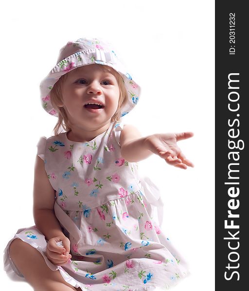 The little girl in a dress with arm outstretched on a white background