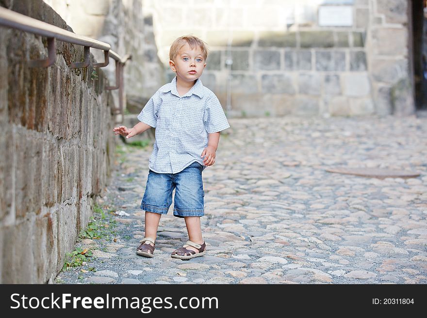 Cute little boy outdoors in city street. Cute little boy outdoors in city street