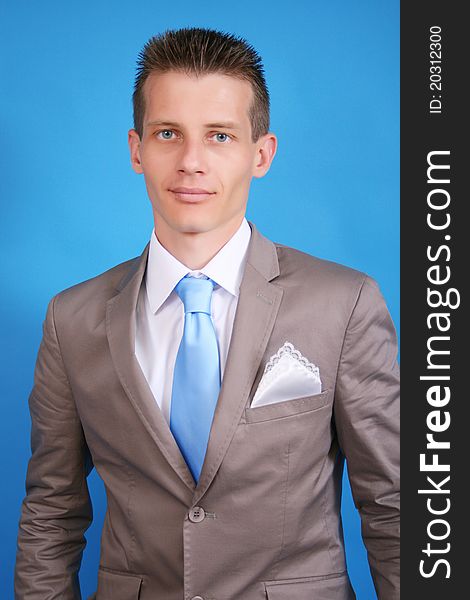 Portrait of groom on a blue background