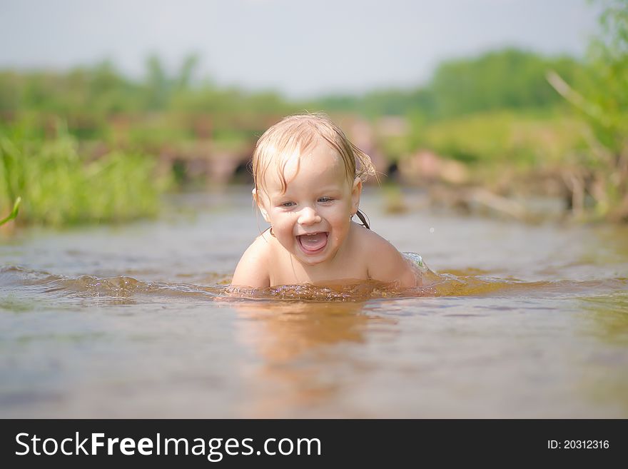 Adorable young baby swim in river. Adorable young baby swim in river