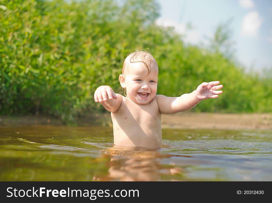 Adorable baby walk in river water