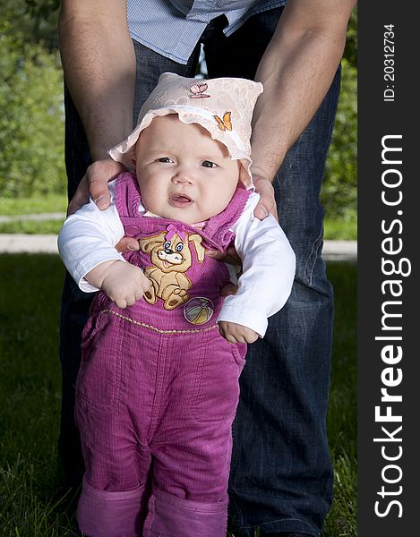 Father playing with baby, raised it high above them, against the background of blue sky. Father playing with baby, raised it high above them, against the background of blue sky