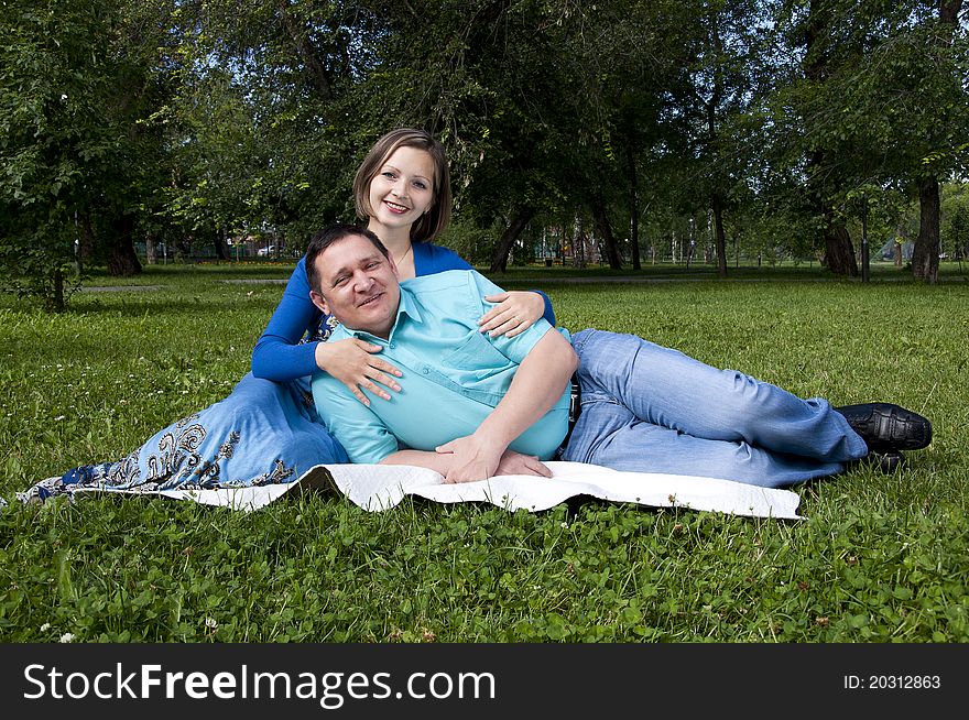 Man and the woman lay together on a coverlet. Man and the woman lay together on a coverlet