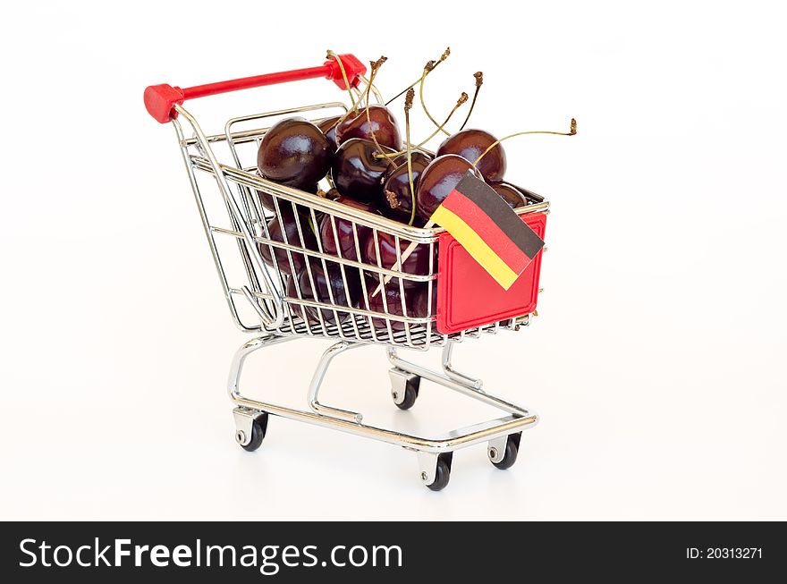 Red cherry in a shopping cart. Red cherry in a shopping cart
