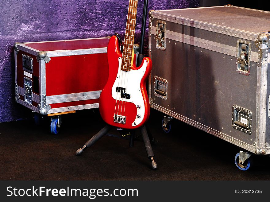 A red bass guitar on a stage