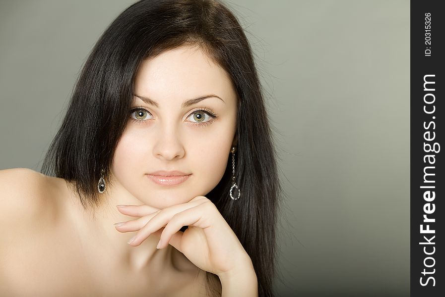 Beautiful brunette girl Ð¾n a gray background