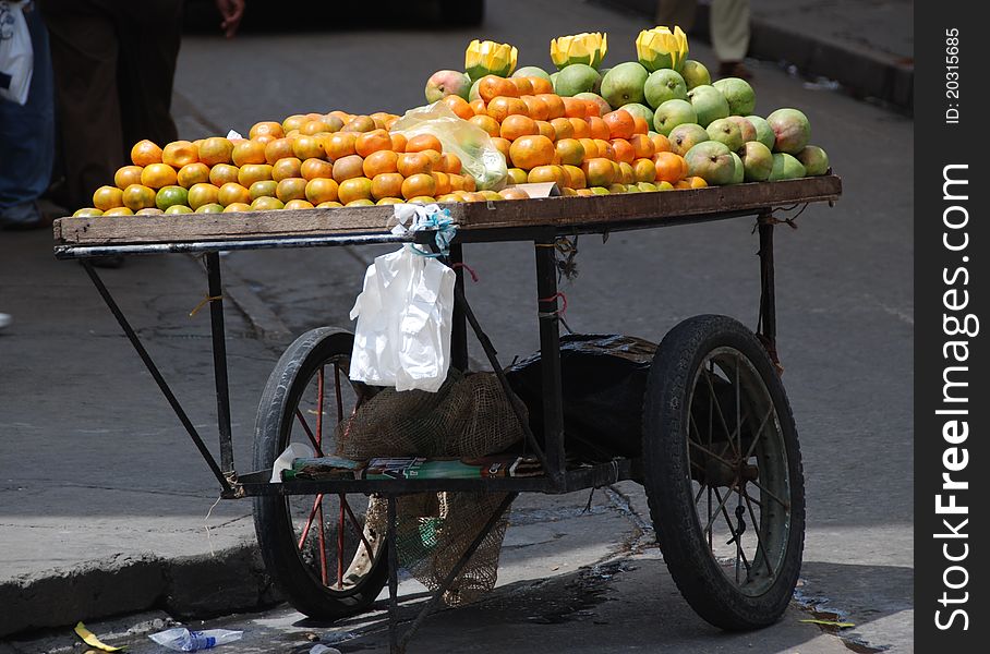 Clementines and Mangos on a cart. Clementines and Mangos on a cart