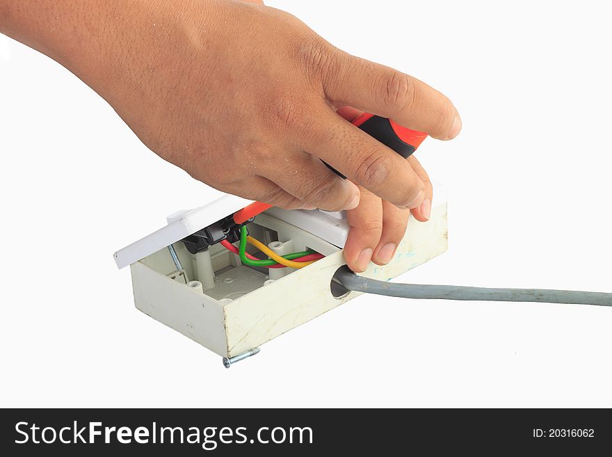 Man electrician's hand holding screw driver and socket outlet, doing troubleshooting to socket outlet. Isolated white background. Man electrician's hand holding screw driver and socket outlet, doing troubleshooting to socket outlet. Isolated white background.