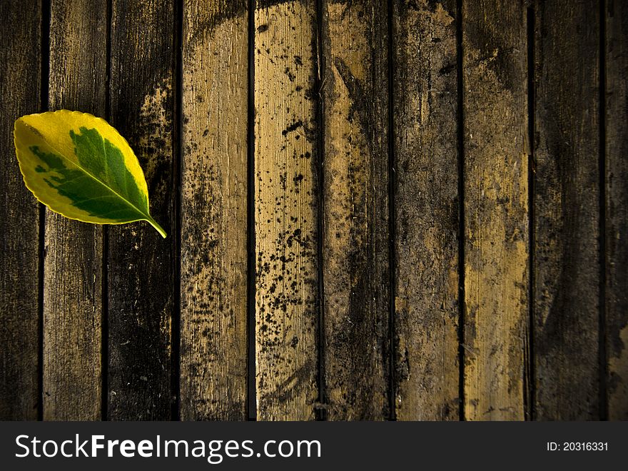 Yellow leaf on an old wooden pad. Yellow leaf on an old wooden pad.