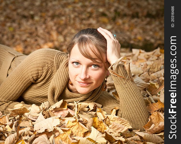 Young Woman In Autumn Leaves