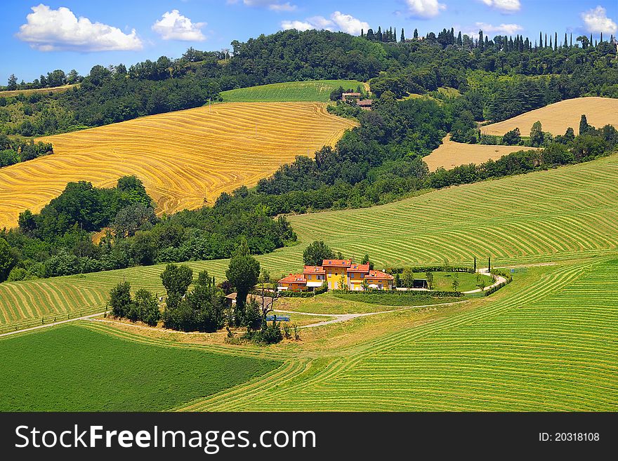 On the photo: Picturesque Tuscany landscape with house.