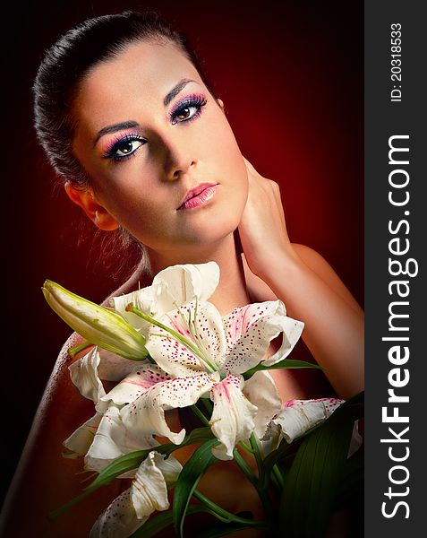 Beautiful young woman with white lily